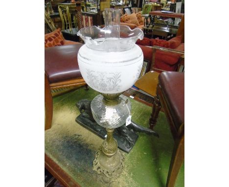 A Brass Paraffin Lamp, with frosted glass shade in the Victorian style.