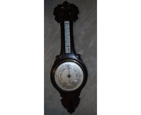 A Carved Oak Framed Aneroid Barometer