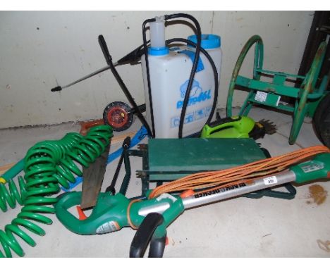 A Black and Decker Strimmer, a hose on a reel and other garden equipment.