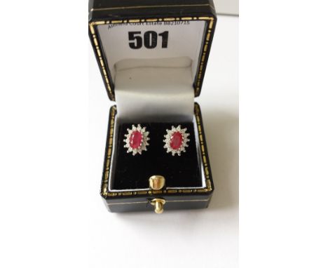 A Pair of Diamond and Ruby Cluster Earrings.