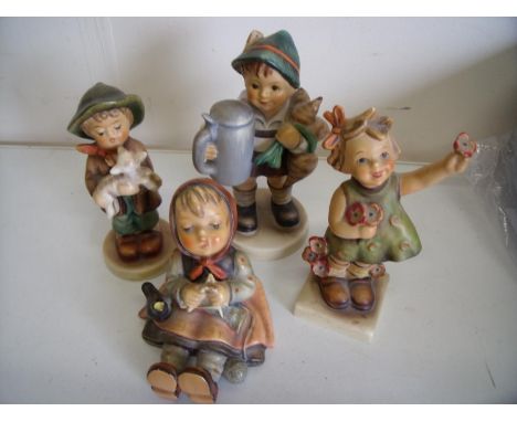 Group of four various Hummel/Goebel figures including seated girl, boy with beer stein etc 