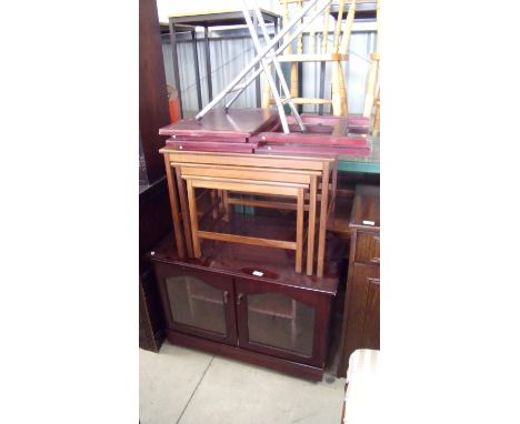 Wooden television cupboard, a set of three mahogany nest of tables, two folding tables and a folding shooting stick 