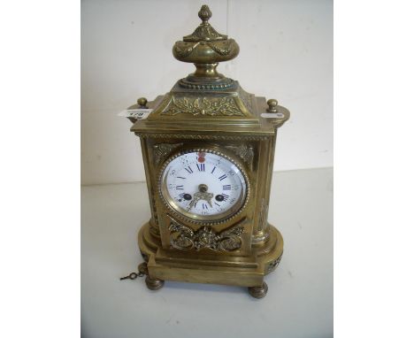 Late 19th C French brass cased striking mantel clock with white and blue enamel dial with urn shaped finial to the top comple