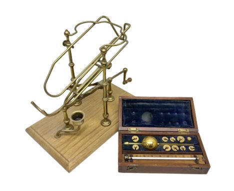 French brass wine pourer with mechanical action all on rectangular wooden base, together with a mahogany cased metal Sykes's 