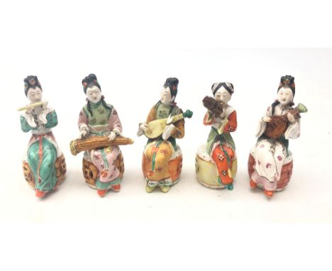 Set of five early 20th century Chinese ceramic musicians, each polychrome decorated, seated on a reticulated garden seat and 