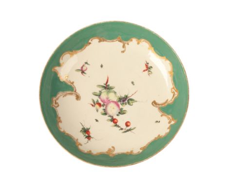 A WORCESTER PORCELAIN SAUCER DISH circa 1770, the shaped pea-green border outlined with gilt scrolling foliage, the centre pa