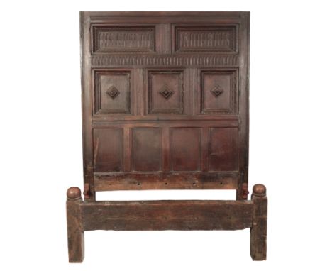 AN ENGLISH OAK BED19th century, the headboard with arcaded and geometric moulded panelling, 174cm high, the footboard with sh