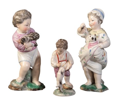 TWO SIMILAR&nbsp;HÖCHST PORCELAIN FIGURES marked to the base with blue wheels and the letter 'D', the boy figured holding a c