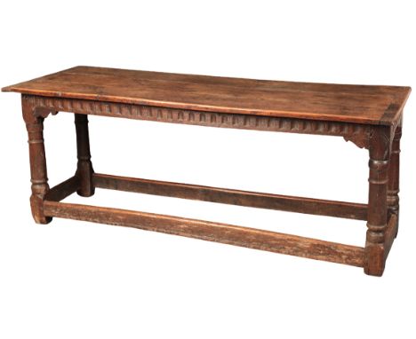 AN OAK REFECTORY TABLE17th century and later, the three plank top over a moulded frieze, on turned legs joined by stretchers,