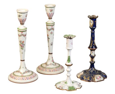 A BATTERSEA-STYLE ENAMEL CANDLESTICK18th century, decorated with floral sprays within blue and gilt reserves, 31cm high; a si