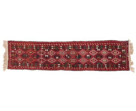 A PERSIAN RUNNER20th century, the dark ground decorated with two rows of geometric medallions, 280cm long x 72cm wide