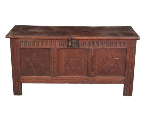 AN ENGLISH OAK COFFER 17th century, the hinged lid opening to an interior fitted with a 'candle box', the panelled front carv