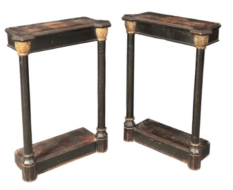 A PAIR OF EBONISED AND PARCEL GILT CONSOLE TABLES19th century, the inverted breakfront tops on turned pilasters with Corinthi