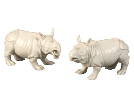 A PAIR OF MEISSEN PORCELAIN RHINOCEROS 19th century, bearing blue crossed swords marks to the bases, modelled in opposing sta