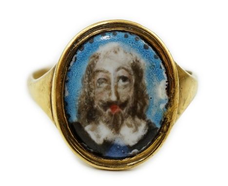 A mid 17th century Charles I gold and enamel oval memorial ring, the ring head with enamelled portrait of Charles I and engra