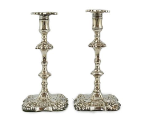 A pair of early George III silver candlesticks, by James Stamp &amp; John Baker, with waisted knopped columns, on quatrefoil 