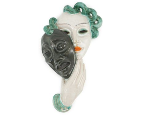 An Art Deco tin-glazed terracotta theatrical wall mask, by Goldscheider, black printed mark ‘Goldscheider, made in Austria’, 