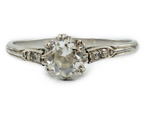 A platinum? and single stone diamond set ring, with six stone diamond chip set shoulders, the central stone weighing approxim