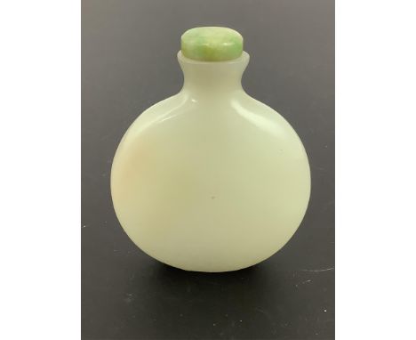 A Chinese pale celadon jade snuff bottle, of moonflask form, 19th century, the stone of good even tone with a hint of russet 