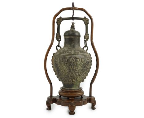 A Chinese archaistic bronze hanging vessel, hu, 17th/18th century, cast in relief with scrolls and lappets, the domed cover w