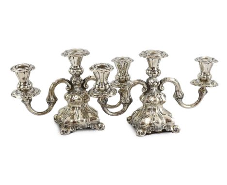 A pair of 1940's Danish silver two branch, three light dwarf candelabra, by Hans Jensen &amp; Co, with scroll arms, on four s