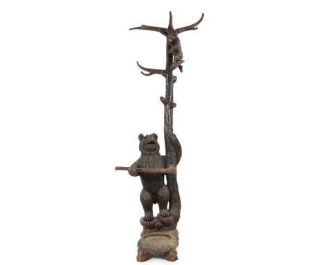 A late 19th/early 20th century Swiss ‘’Black Forest’’ carved wood hall stand, the mother bear depicted wrapped around the bas
