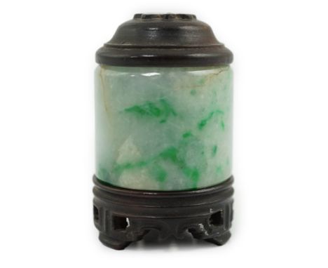 A Chinese jadeite archer's thumb ring, wood stand and cover, 19th century, the ice white stone with emerald green inclusions,