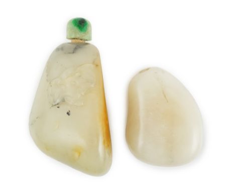 Two Chinese jade pebble snuff bottles, 19th century, the larger pale celadon and russet skin jade snuff bottle carved in reli