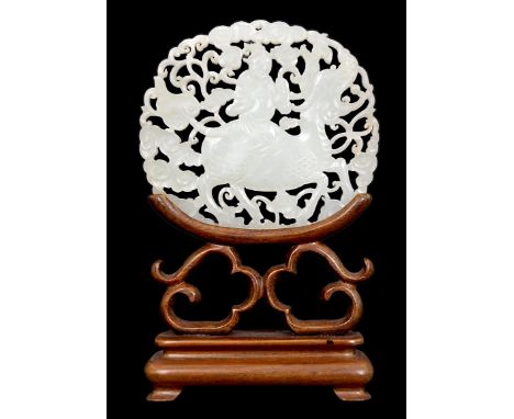 A Chinese white jade ‘qilin and rider’ plaque, 18th/19th century, carved and pierced to each side with a man riding on the ba