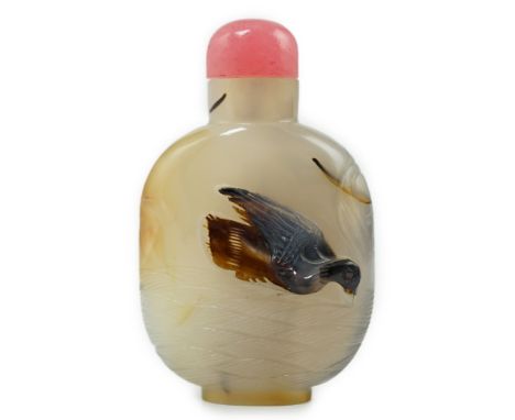 A Chinese shadow/cameo agate 'duck in a pond' snuff bottle, 19th/20th century, carved in relief to a dark inclusion in the st