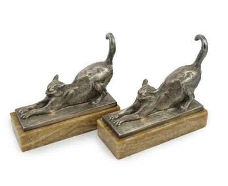 Louis Riché (French, 1877-1949), a pair of silvered bronze bookends modelled as stretching cats, signed in the bronze, on ony