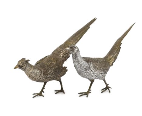 A large pair of German 800 standard silver free standing model pheasants with articulated wings, c.1930, 46cm long circa 1930