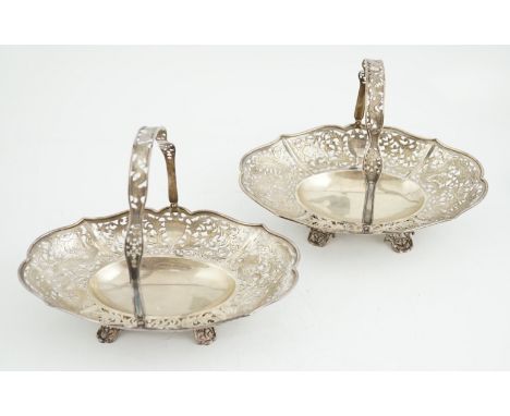 A pair of early 20th century Chinese Export pierced silver cake baskets, by Wang Hing, Hong Kong, decorated with dragons and 