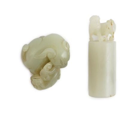A Chinese white jade lion-dog seal and a Chinese pale celadon  jade group of a lion dog and cub, 19th century, the cylindrica