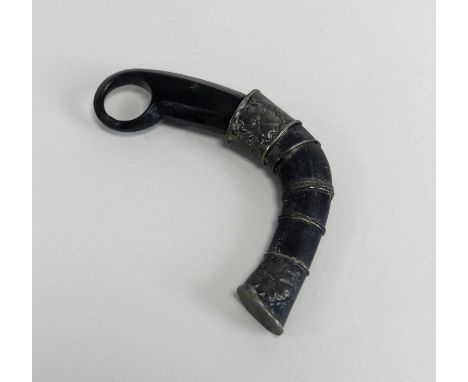 An Indonesian Karambit Claw knifeearly 20th century, with hole finger grip, leading to a curved body and blade in the form of