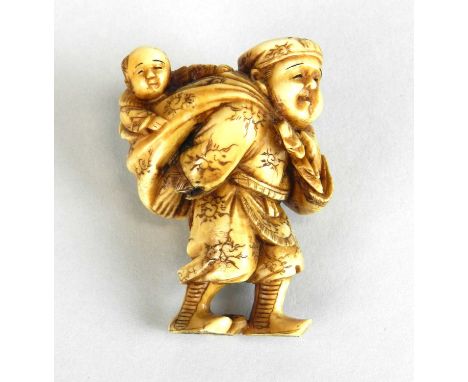 A Japanese netsuke of a farmer with his son in a papoose on his back, signed Tamayama, 4.5cm