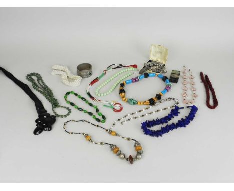 A collection of costume jewellery, to include; silver and white metal brooches, a dyed jade pendant, a large hinged white met