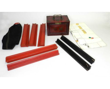 An early 20th century brass mounted hard-wood cased, mah-jong set, the case with carrying handles and a sliding front enclosi