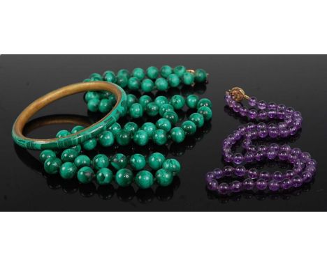 A beaded and knotted malachite single string necklace, 78cm; together with a malachite on brass bangle; and a beaded amethyst