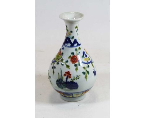 A Chinese export porcelain vase, having a flared rim to a slender neck and bulbous lower body, enamel decorated with various 