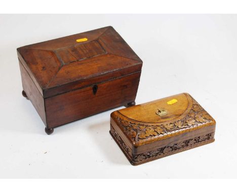 A Regency mahogany tea caddy, of sarcophagus form with kite shaped escutcheons standing on four ball feet