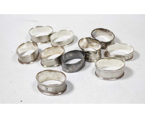 Ten various silver napkin rings, to include engine turned and engraved examples, all being of oval form, various dates and ma