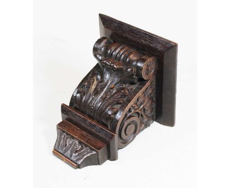 An early 20th century carved dark oak bracket, decorated with scrolls and acanthus leaves, height 17cm