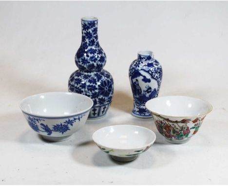 A Chinese export blue and white bowl, decorated with a bird perched upon a branch with flowers, having four character mark ve