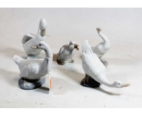 A Lladro figure of a goose, having printed mark verso, h.12cm; together with four Nao geese (5)