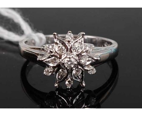 A contemporary 18ct white gold diamond flower-head cluster ring, arranged as thirteen small brilliants in a tiered flower-hea