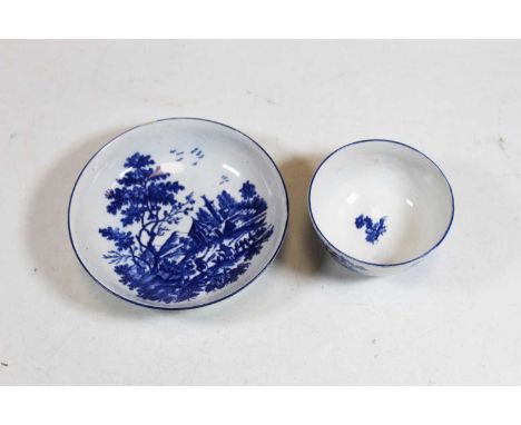 An 18th century Worcester blue and white tea bowl and saucer, decorated with figures before a pagoda within a mountain landsc
