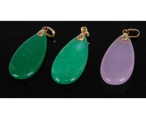 A pair of polished green jade elliptical pendants, with 14ct gold mounts, 3cm; together with a similar rose quartz example (3