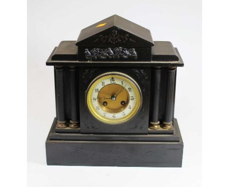 A Victorian black slate mantel clock of architectural form, relief decorated with birds, the dial with enamelled chapter ring