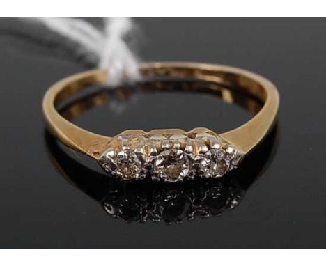 An 18ct gold diamond three-stone ring, the claw set old brilliants weighing approx 0.11 carats, 2.1g, size O/P